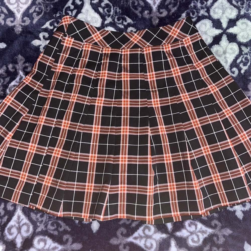 orange-red pleated plaid skirt